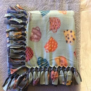 50x60” fleece tie blanket. Tea cup pattern fleece with gray fleece backing.
